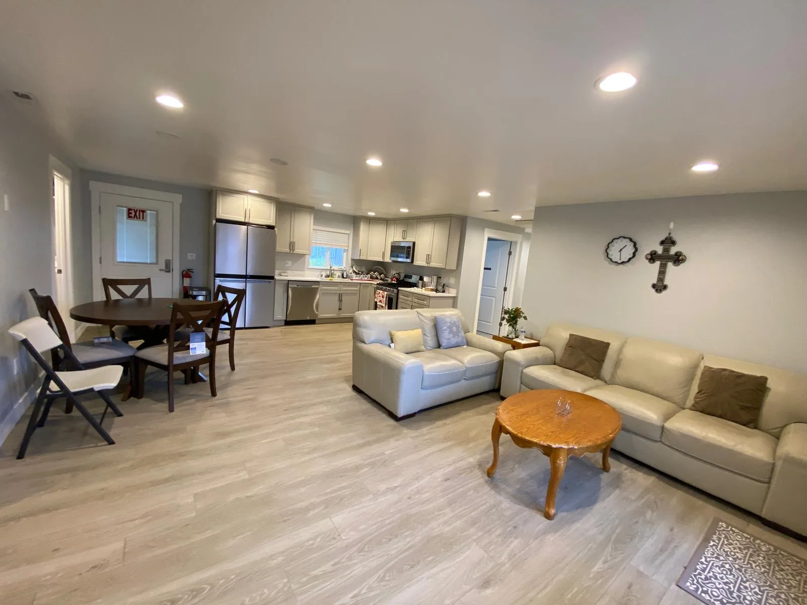 Bright shared living room, dining area, and kitchen at Umbrella Two Adult Family Home